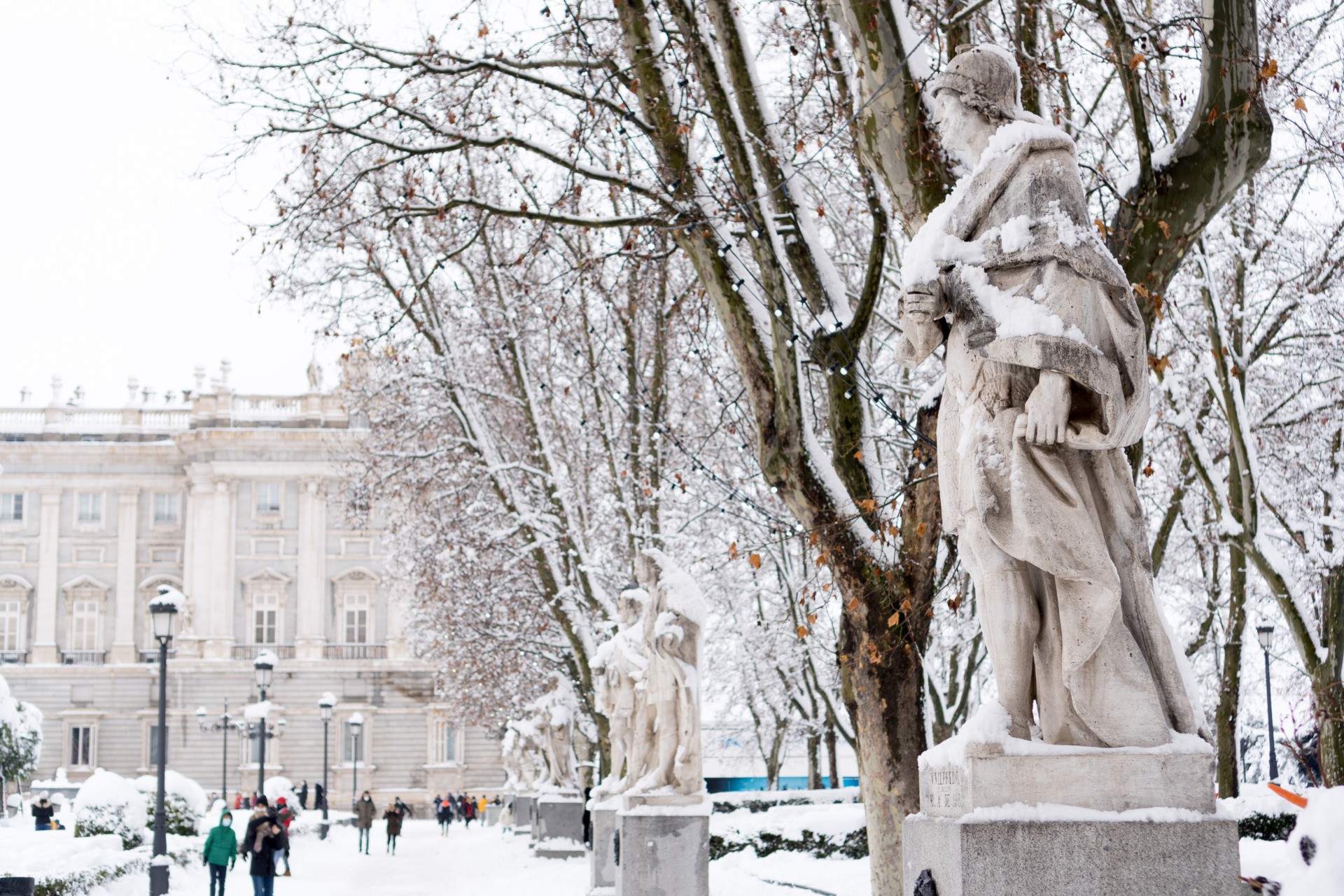 statues covered by snow in the plaza de oriente in 2026 01 08 05 35 57 utc